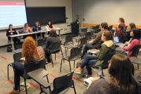 Students listen to a panel discussion during a Development Academy